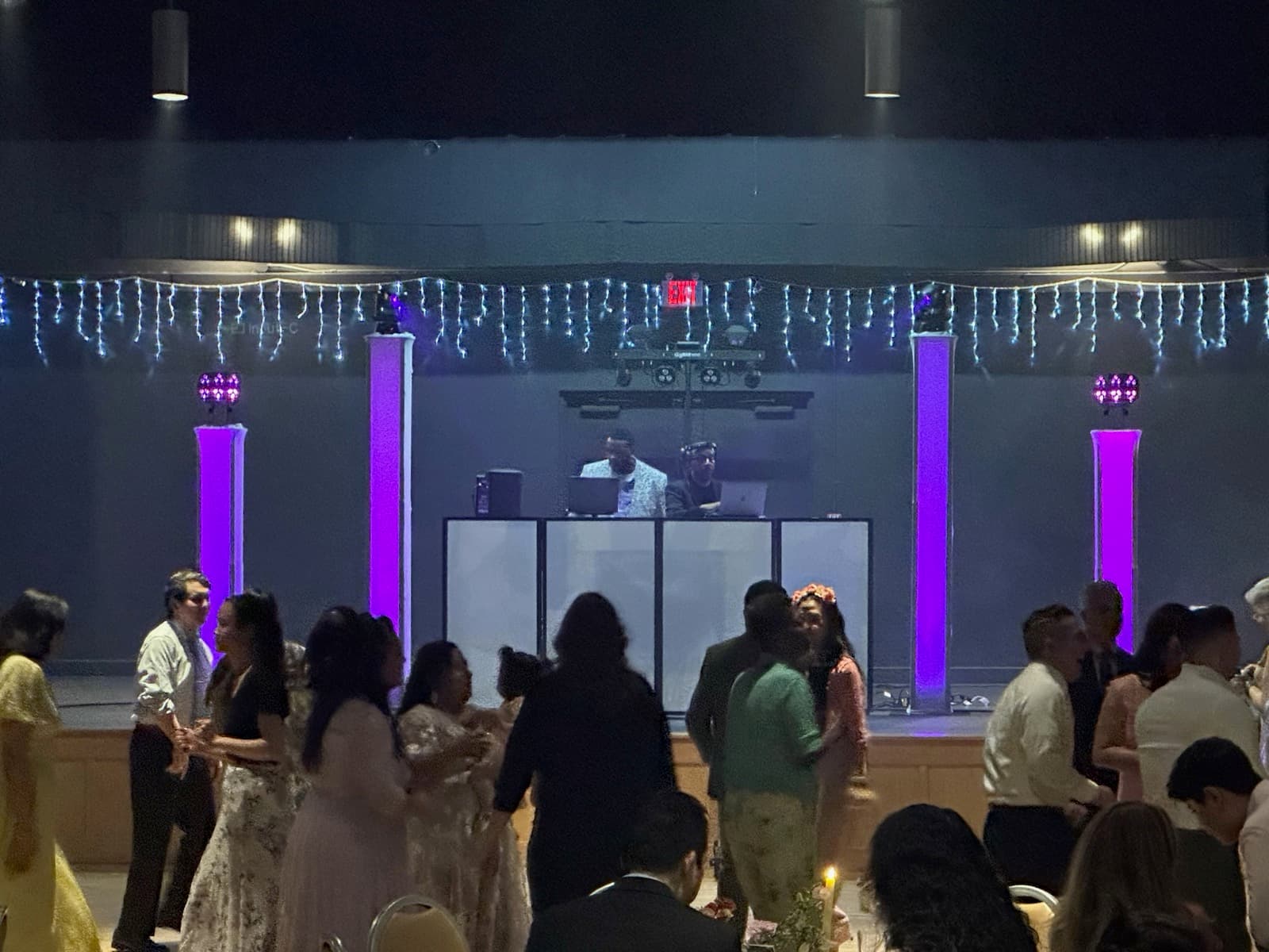 DJ booth with purple uplighting at the Correa reception