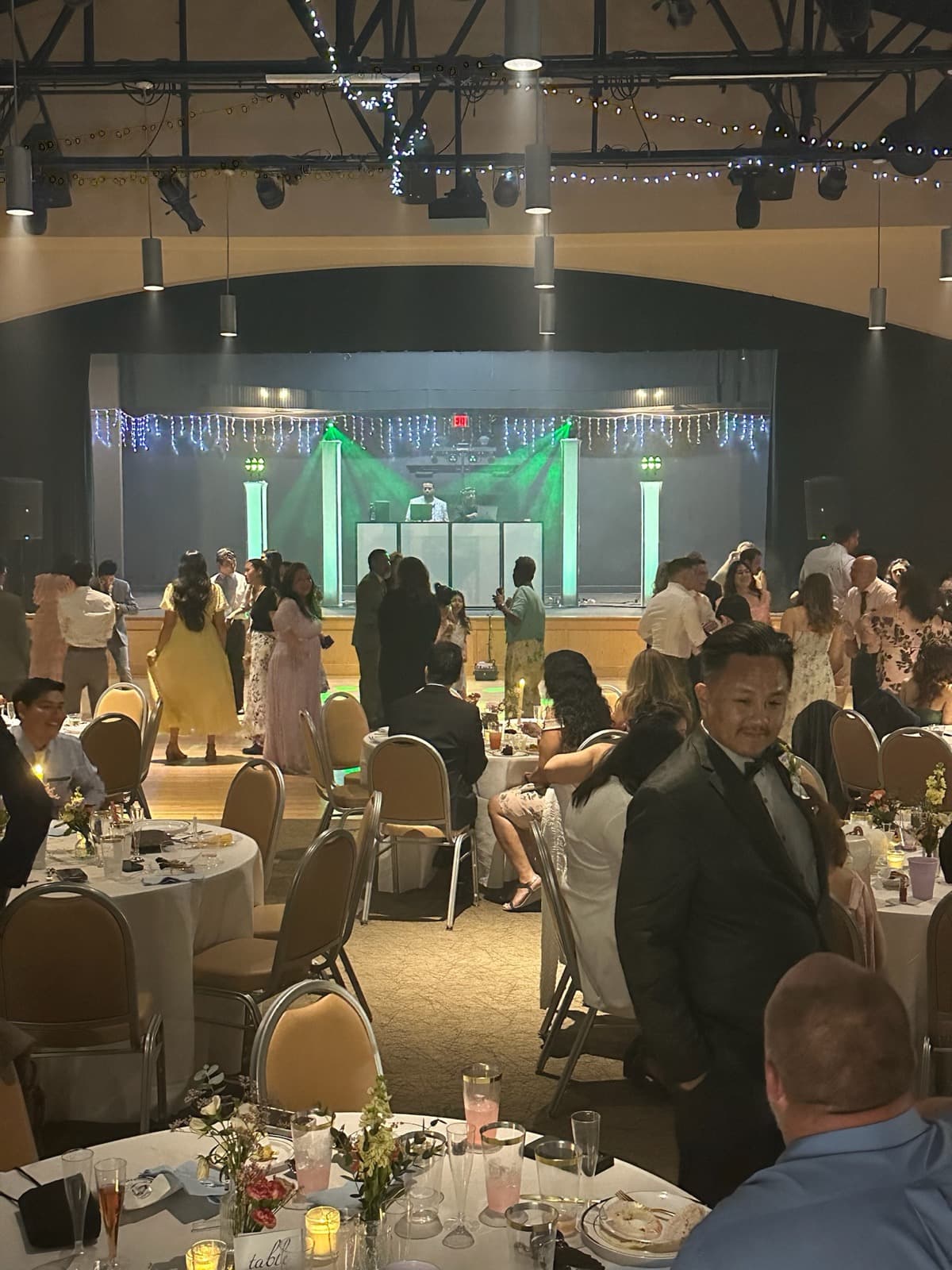 DJ booth with green lighting at the Correa reception