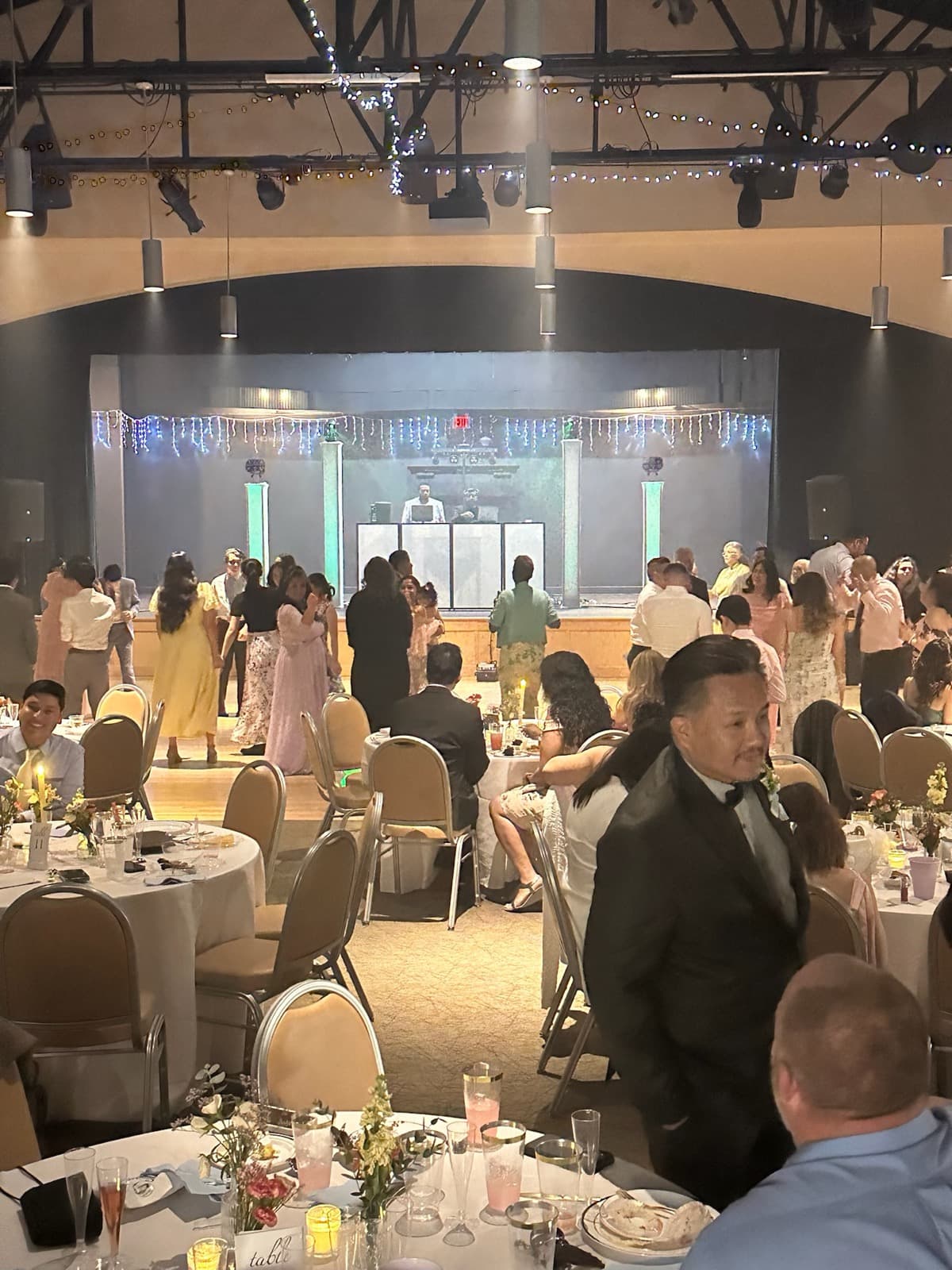 Full reception hall with DJ on stage at the Correa event